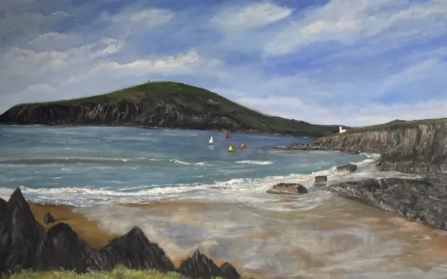 A scenic coastal landscape painting features a calm sea with small sailboats and yellow buoys. Rocky cliffs and a sandy beach are in the foreground, and a grassy hill with a small building on top is in the background under a partly cloudy sky.