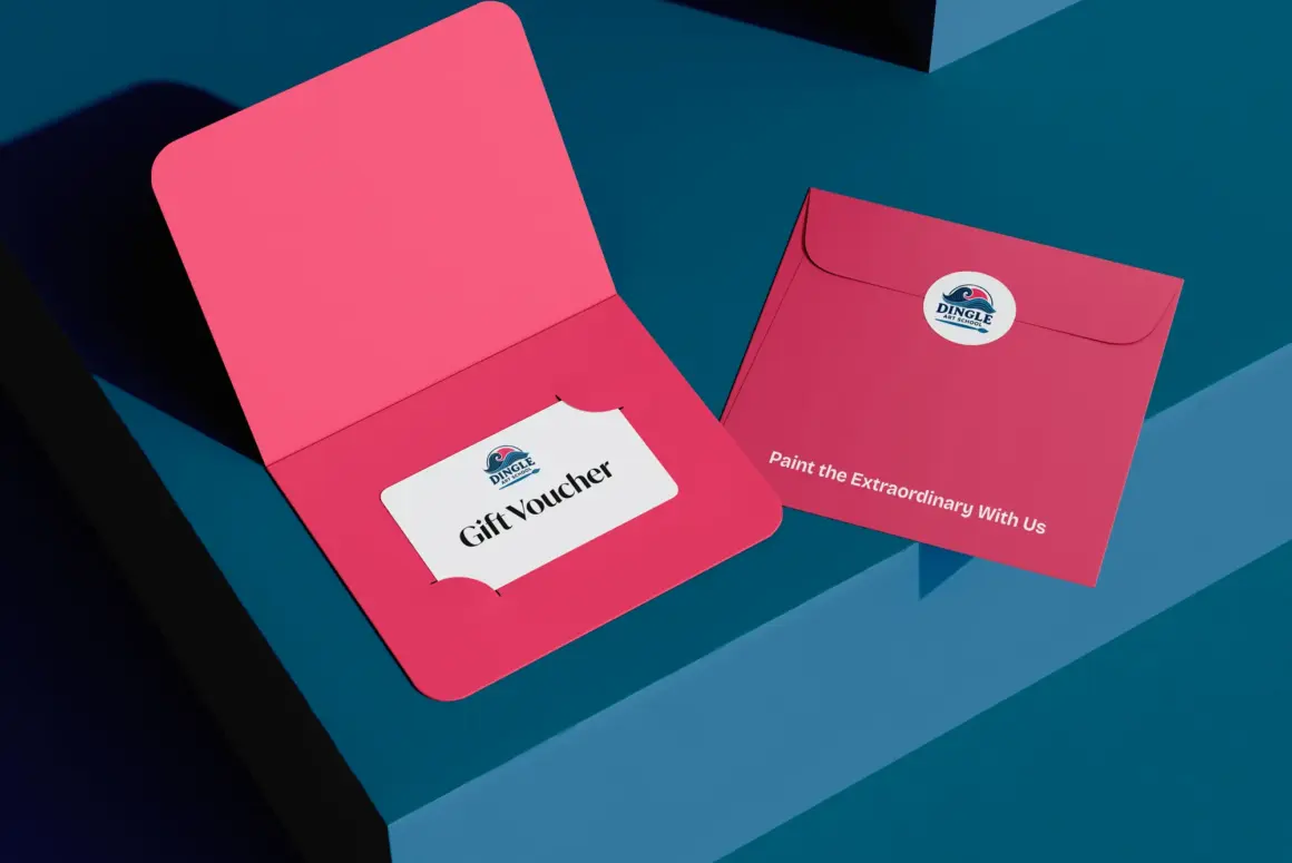 A pink gift voucher envelope reveals a “Gift Voucher” card, while a closed envelope with the Dulux logo and “Paint the Extraordinary With Us” rests nearby on a blue geometric surface—perfect for presenting Dingle Art Gift Vouchers.